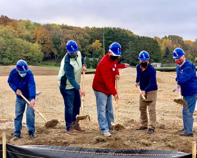 men in masks at groundbreaking